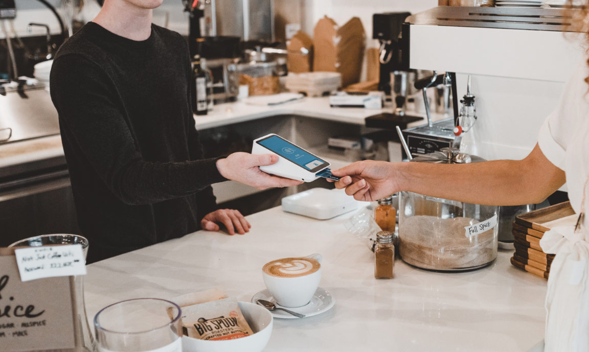 Someone Making a Card Payment in a Cafe