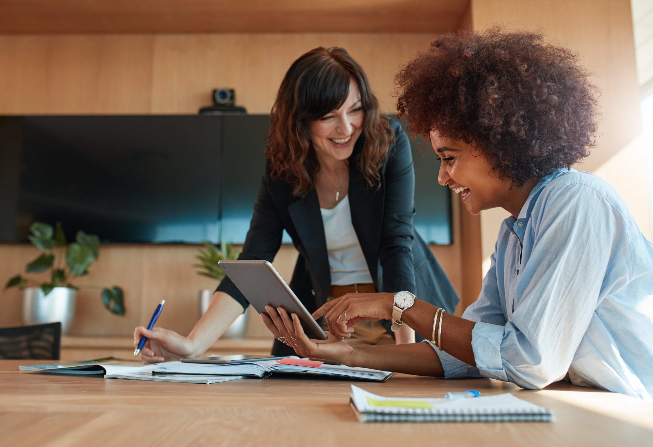two female colleagues smiling scaled
